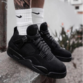 Air Jordan 4 Retro Black Cat 2025 sneakers in black worn by model