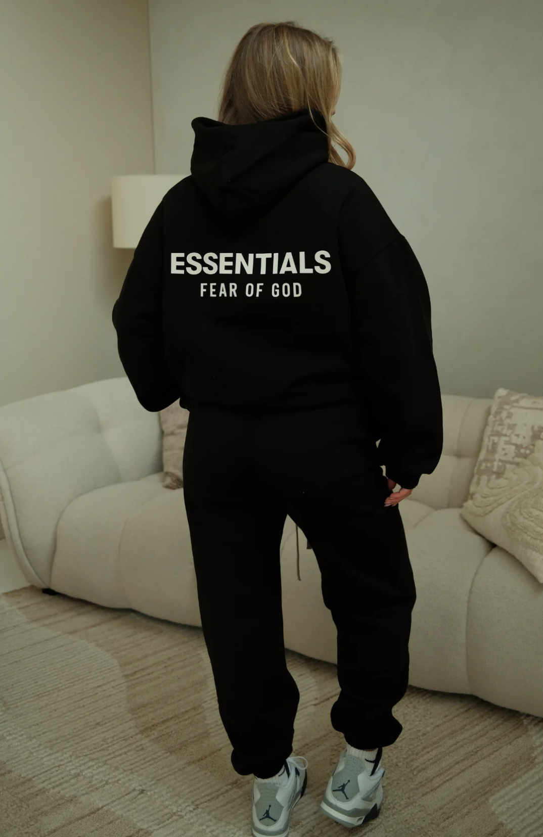 Fear of God ESSENTIALS hoodie and sweatpants set in black white worn by model back view