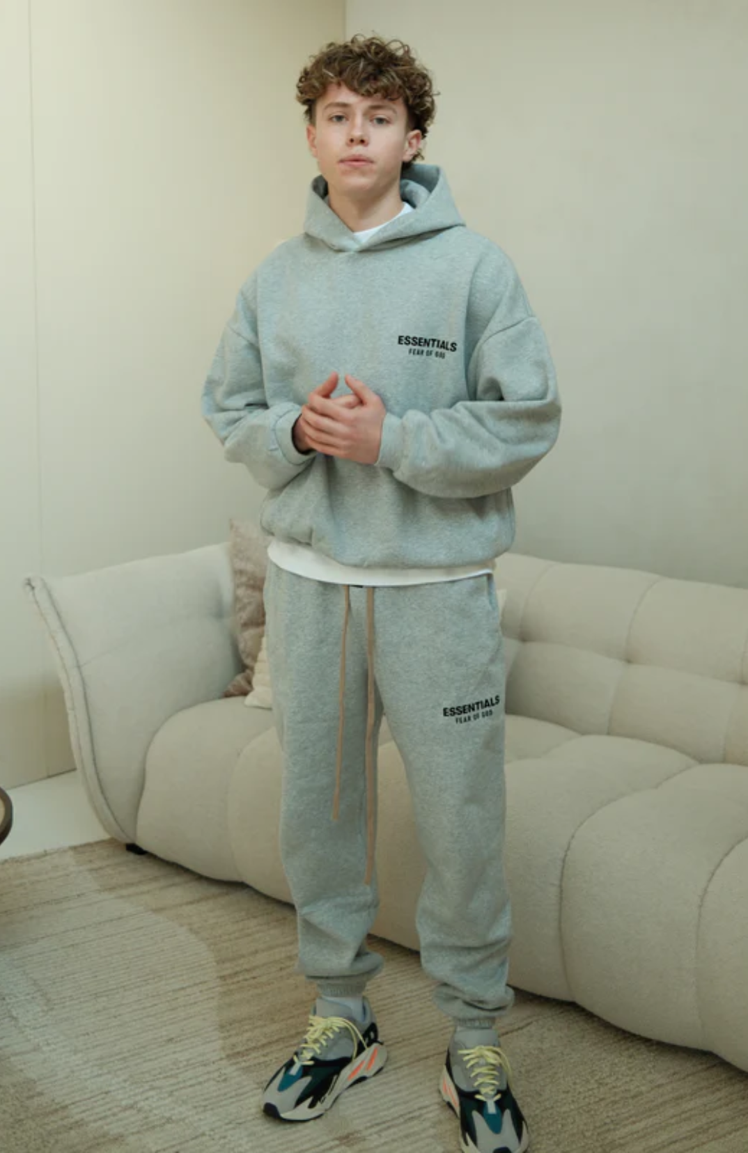 Fear of God Essentials FW24 Light Heather Full Set hoodie and sweatpants set in light heather worn by model