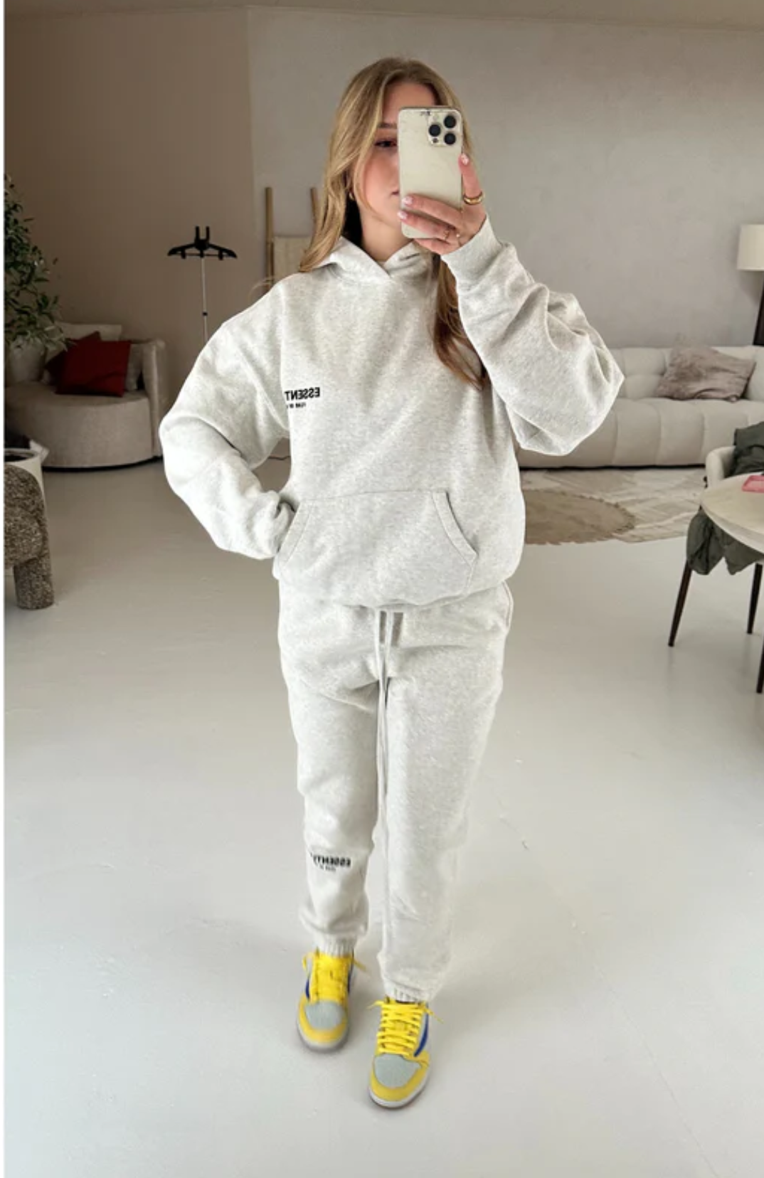 Fear of God ESSENTIALS Light Oatmeal Full Set hoodie and sweatpants set in light oatmeal worn by model alternate view