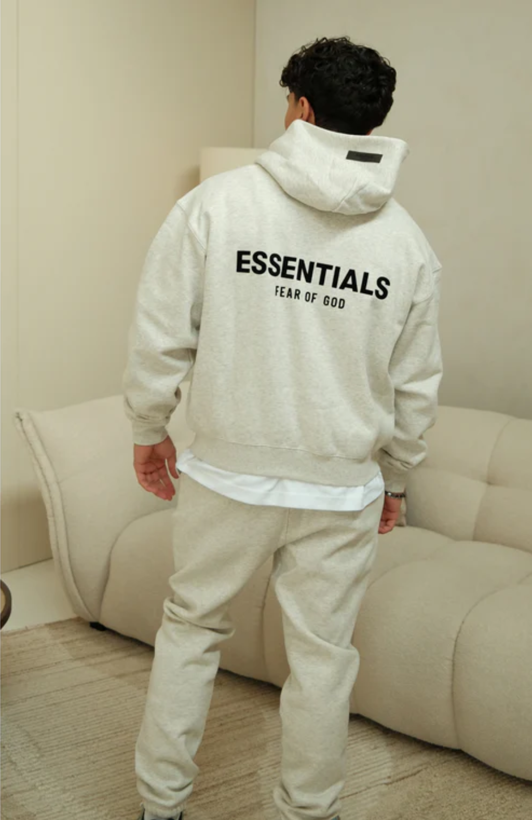 Fear of God ESSENTIALS Light Oatmeal Full Set hoodie in light oatmeal back view worn by model