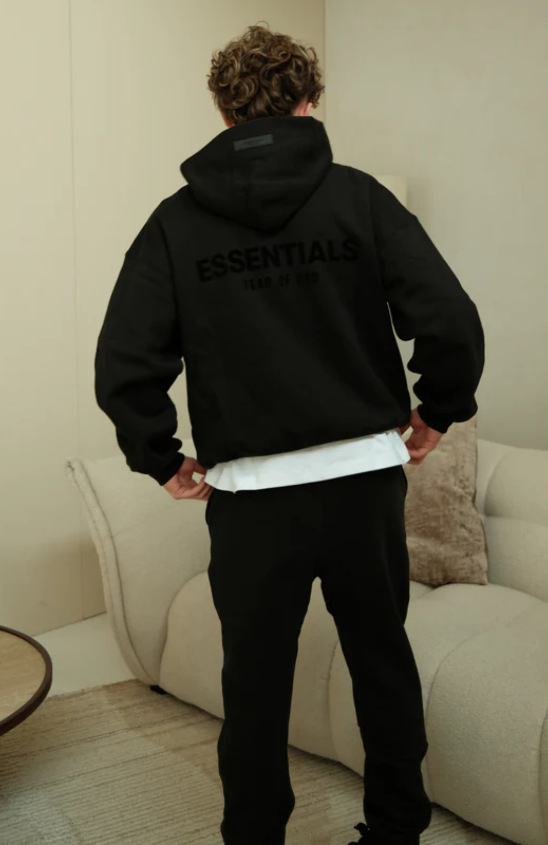 Fear of God Essentials Limo Black Full Set hoodie in limo black back view worn by model