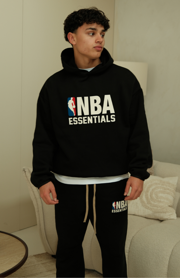 Fear Of God Essentials NBA Black Full Set hoodie and sweatpants set in black worn by model